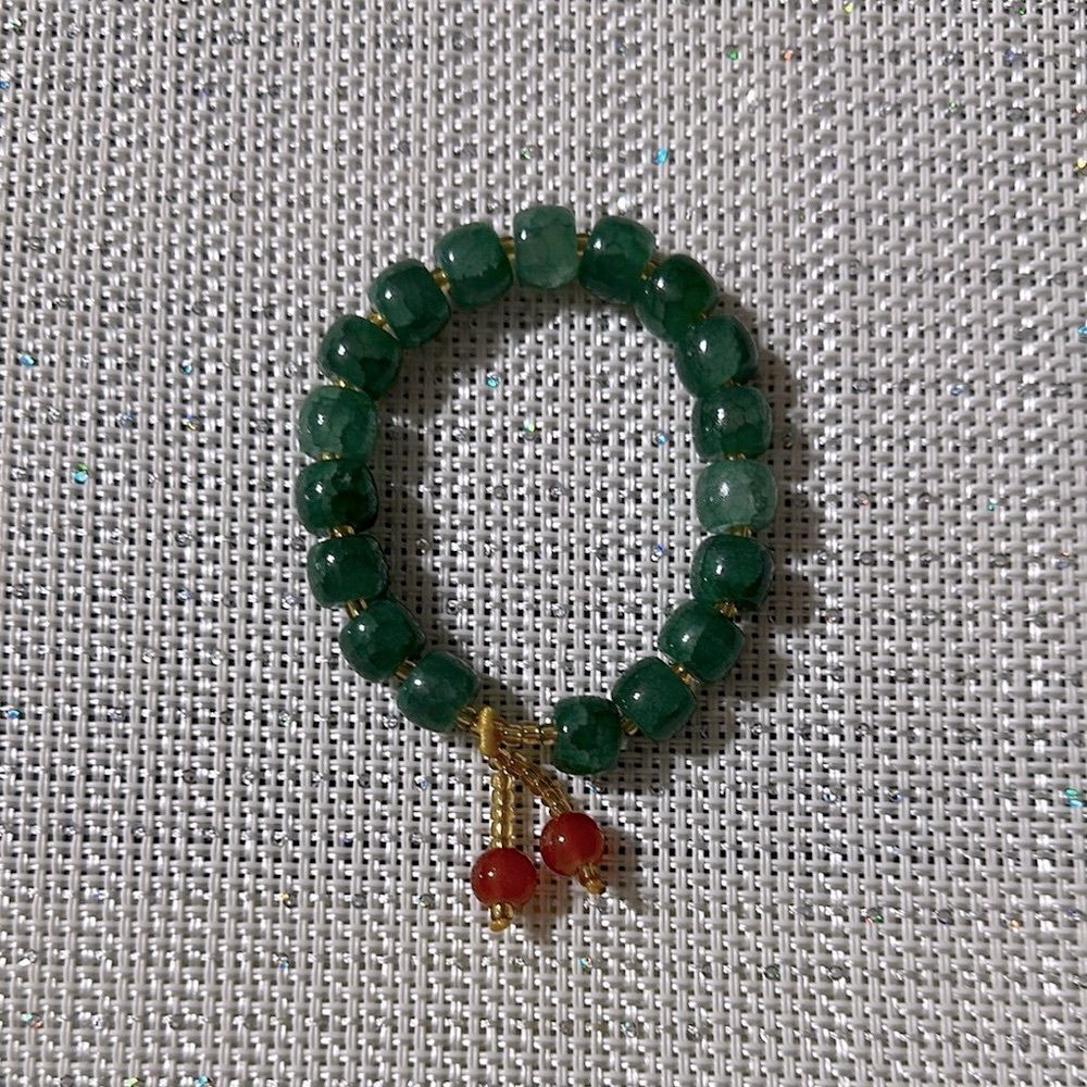 Handmade Green Jade Stretch Bracelet with Small Rust Tasseled Design
